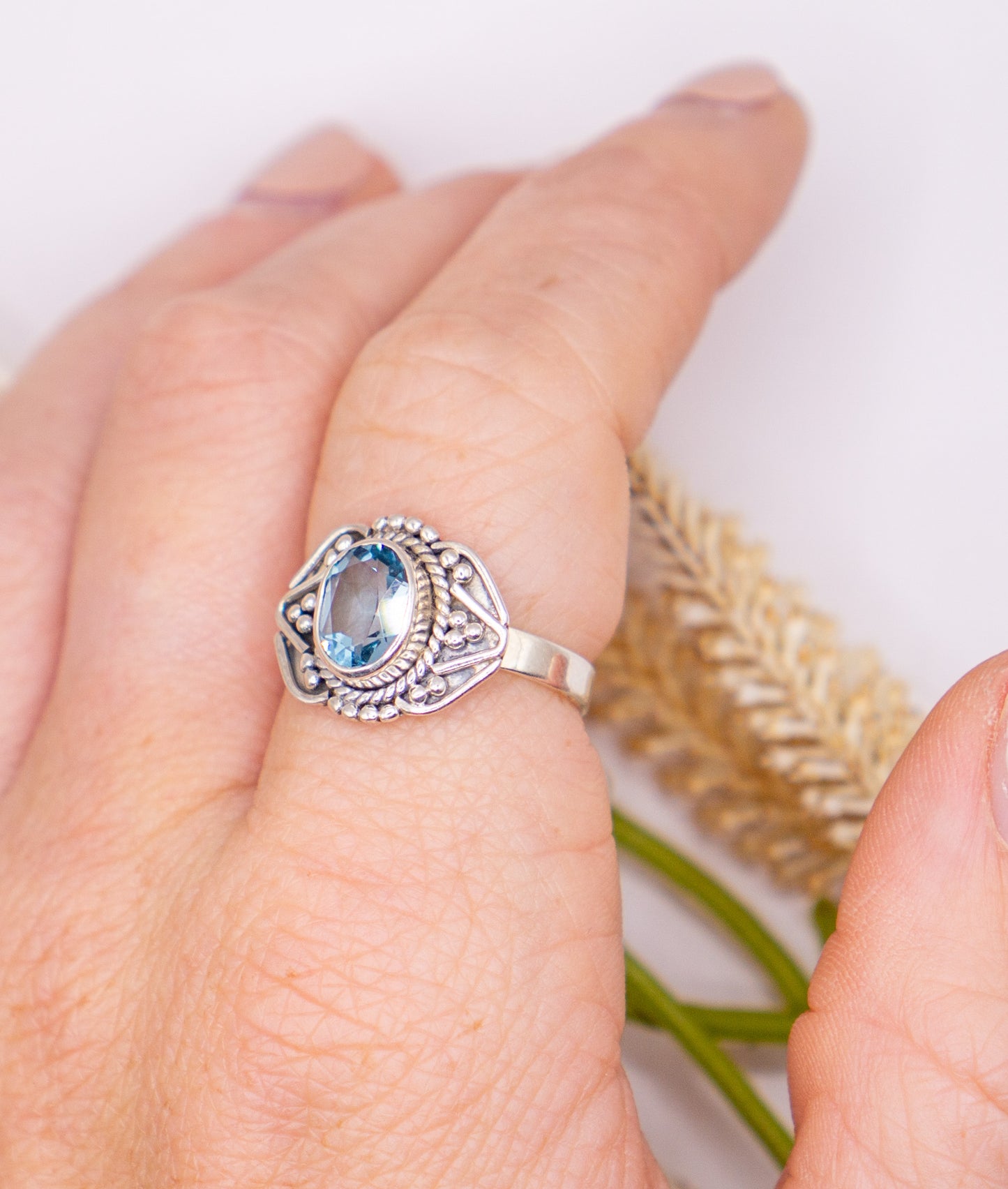 Oval Blue Topaz with Scroll Detail